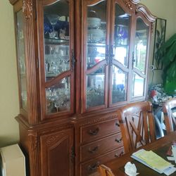 Beautiful 4 glass doors with beveled glass custom wood carvings comes in 2 pieces bottom has 3 drawers and 2 swing side doors great condition just nee