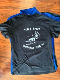 Black vintage ski inn Bombay Beach t-shirt with white graphic of a person on a watercraft  #beach