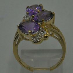 10kt yellow gold ring size 6 with 3 oval amethysts ; 6 diamonds 0.05 carat ; 3.8 gr total weight . 849101-1