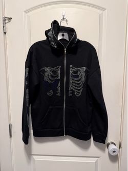 Unisex basement zip-up hoodie features rhinestone skeleton and butterfly details on the chest size small