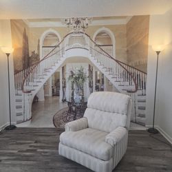 Cream-colored fabric upholstered recliner chair with a vertical striped pattern. 