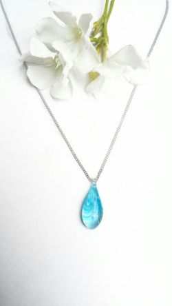 Necklace with handblown glass teardrop pendant with painted light blue swirls on a silver colored chain