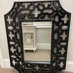 Olivia wall mirror. Overall: 43” H x 33” W x 1.5” D. HAS SMALL CRACK IN FRAME. Wall mounted. Frame design: ornate. Frame material: resin. Finish: blac