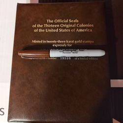 The Official Seals of the Thirteen Original Colonies of the United States of America". The album contains 23-karat gold-plated replicas of the seals, 