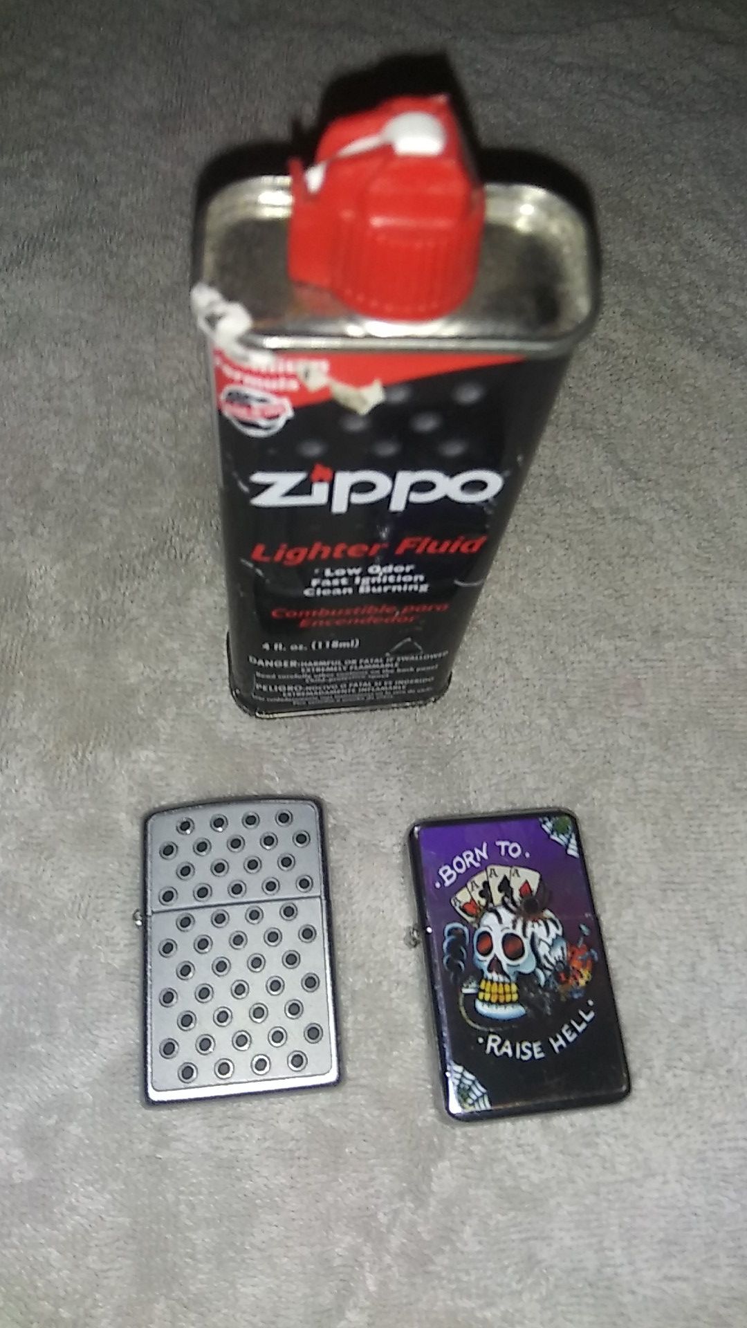 Two zippo lighters and half can fluid
