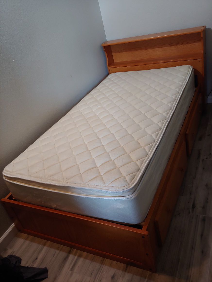 Twin bed for sell, includes pillow top mattress and frame with storage space.