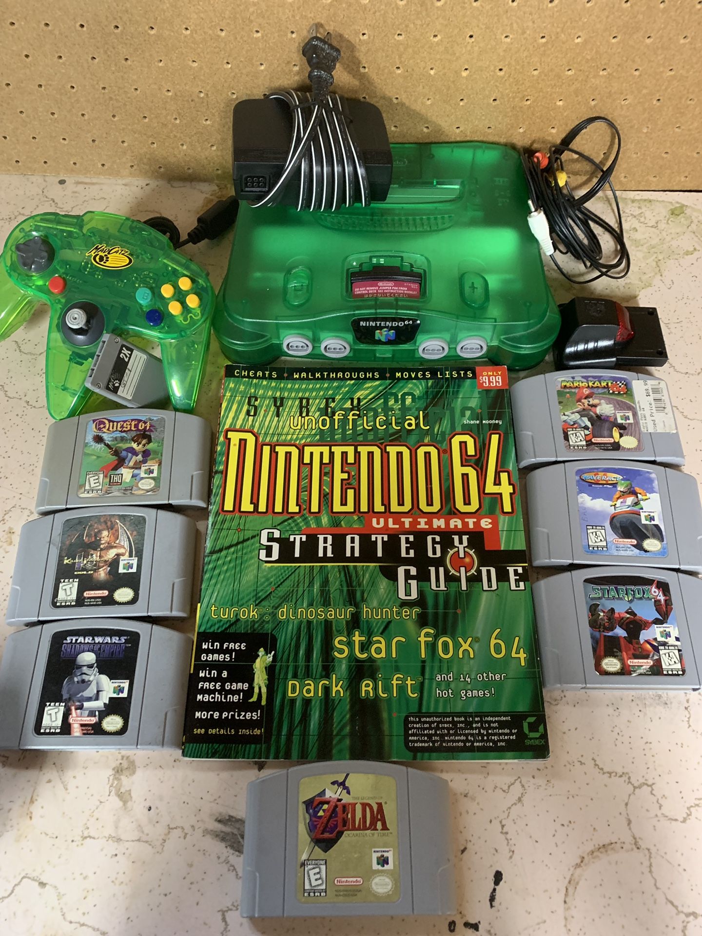Nintendo 64 (jungle green n64 ) with 7 games , 1 controller, memory card , and tremor pak, (Zelda ocarina of time , Star Fox , Star Wars , killer ins