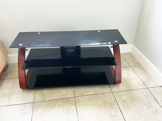 Modern glass TV stand with wooden accents and two shelves