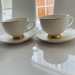 two cups with tea stand