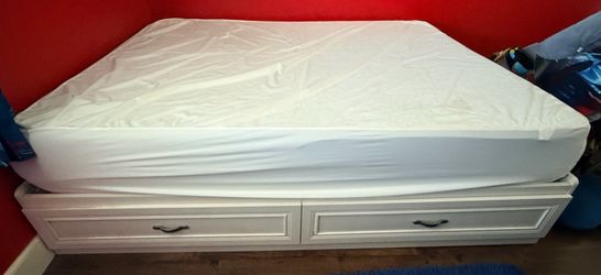 Full-size bed frame with drawers and mattress