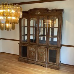 Solid Wood Ornately Decorated Dining Room Cabinet With Glass Paneled Doors And Glass.
