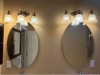 Matching oval mirrors (2) and lighting fixtures