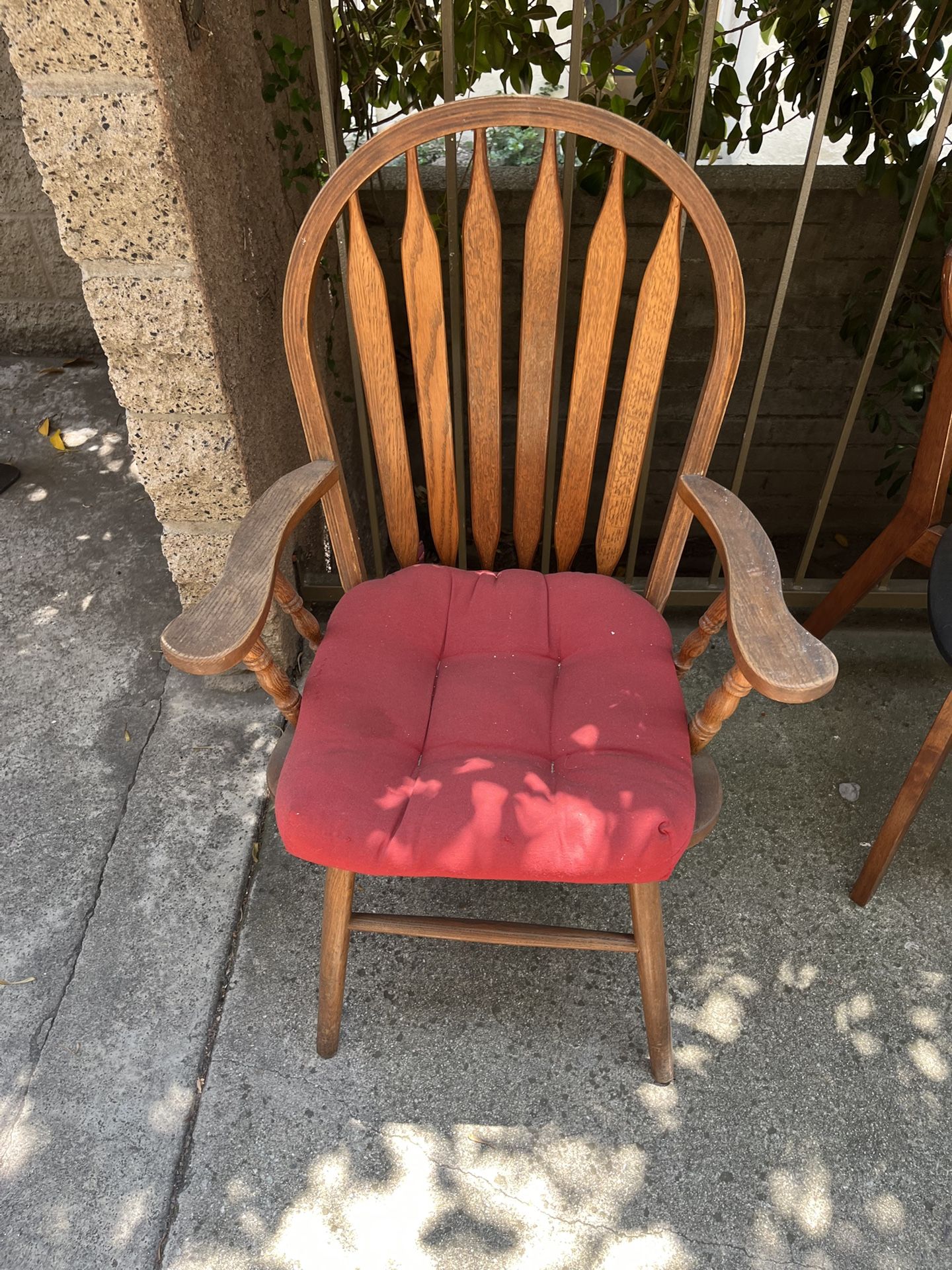 Two Sturdy Wooden Chairs With Red Cushion