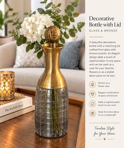 A beautiful decorative bottle with a matching lid, crafted from glass with bronze accents.