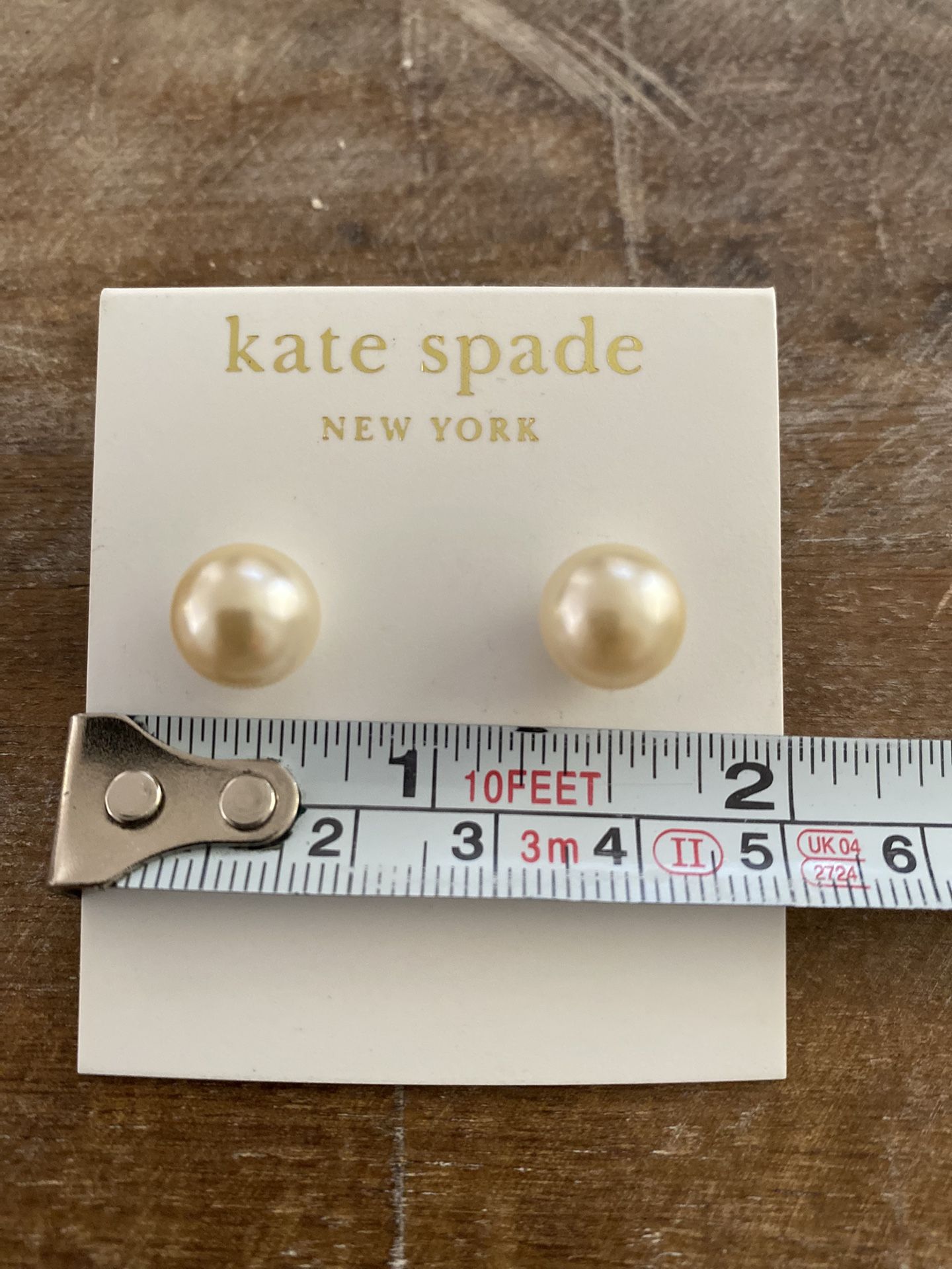 Kate Spade classic pearl imitation stud earrings.
