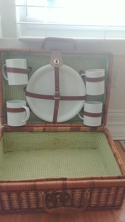 Picnic basket with dishes and cups