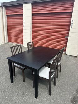 Black wooden table and four chairs