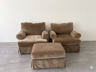 A pair of sofas with footstools