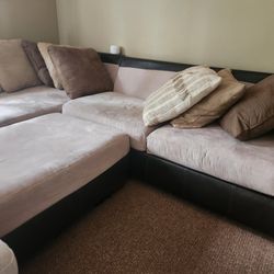 L shaped TAN SOFA WITH OTTOMAN with pillows