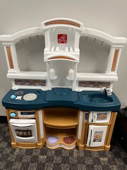Kid's play kitchen with utensils and play food