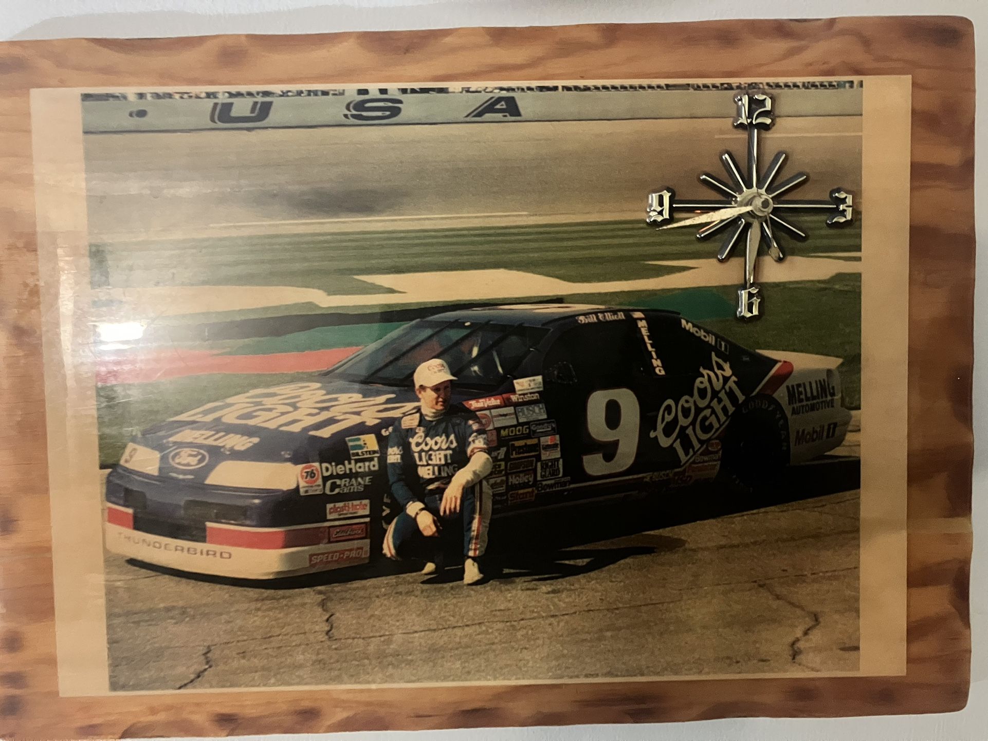Bill Elliott laminated wooden clock runs off of a three a battery works very well