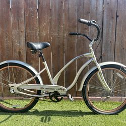 Electra Rosie model 26 inch women’s beach cruiser.  Pearl Silver with Bronze rims.  Three speed internal hub with coaster brake.