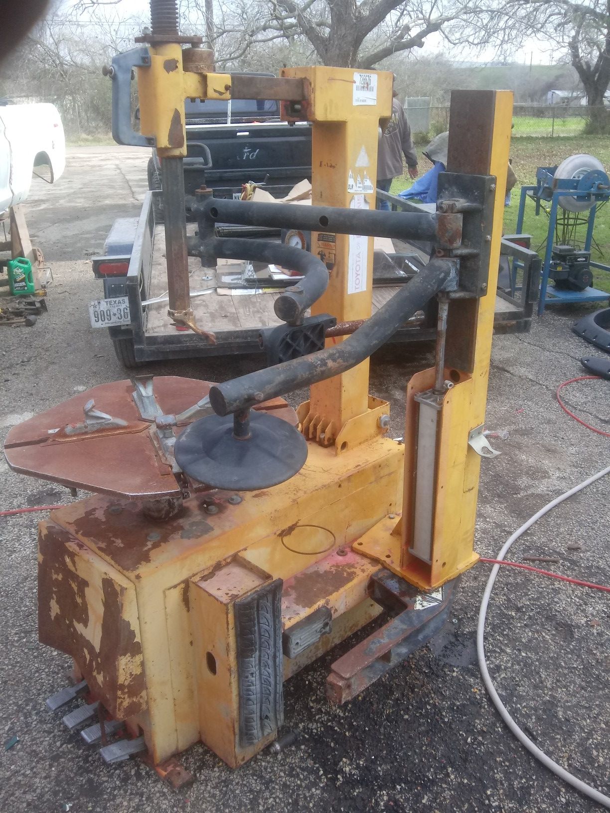 Yellow industrial tire changer w/ extra arm accerry