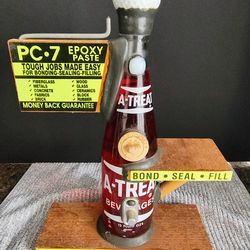 Vintage PC-7 Epoxy Paste counter-top display with an A-Treat soda bottle