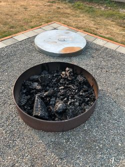 Steel wood burning fire pit with metal cover