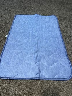 Blue with white stripes pet cooling mat 23 1/2” x 35”.