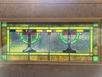 This antique leaded stained glass panel dates back to the early 20th-century Craftsman/Art Nouveau era (circa 1910–1920). It features a rare, stylized