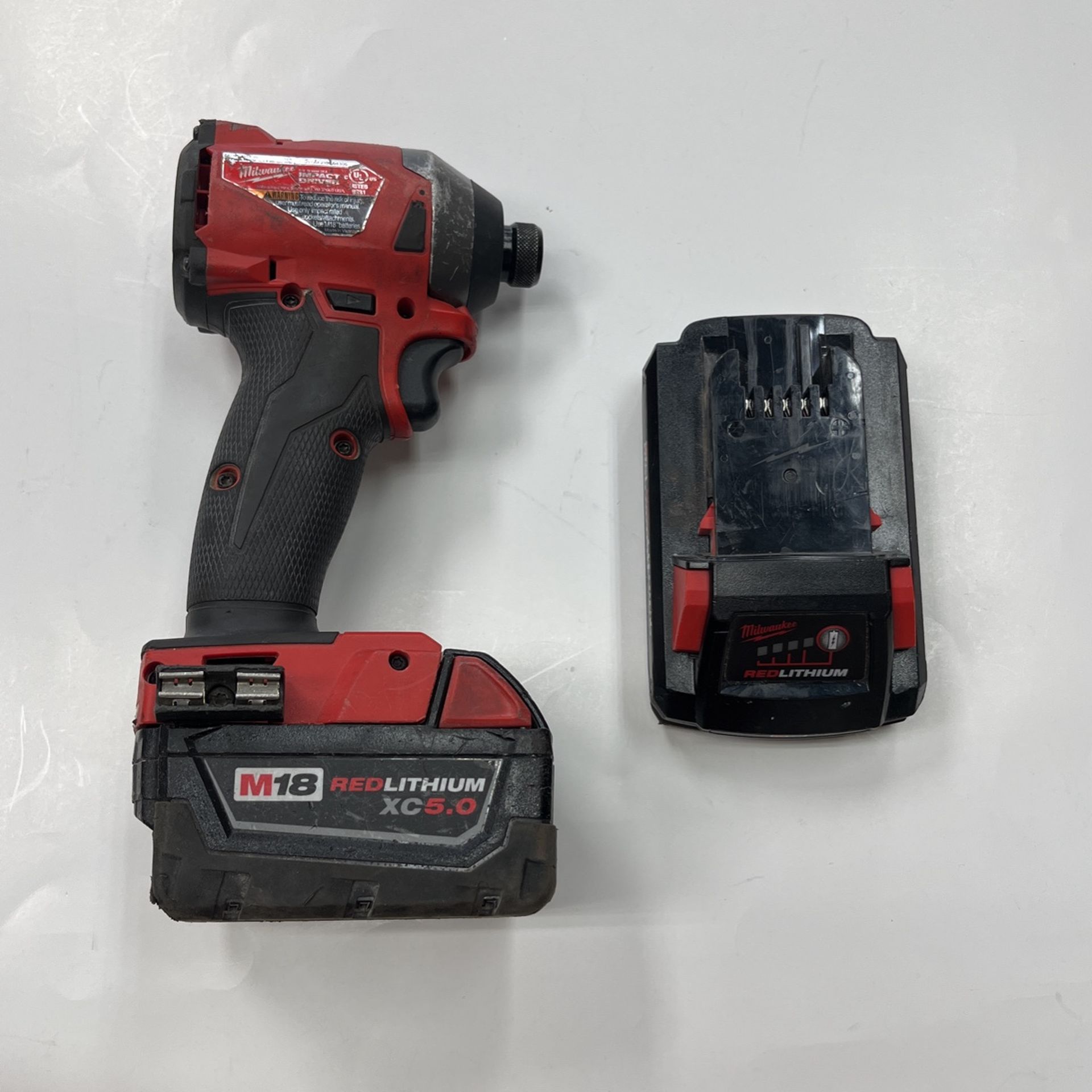 Milwaukee impact driver with red lithium xc 5 0 and cp 3 0 battery no