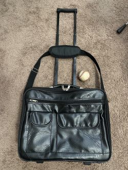 $40 Leather Travel Bag Lockable w/ ext handle and rollers.