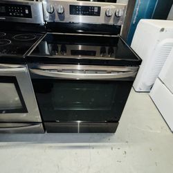 LG electric stove, stainless steel, black, with a receipt for a 90-day warranty