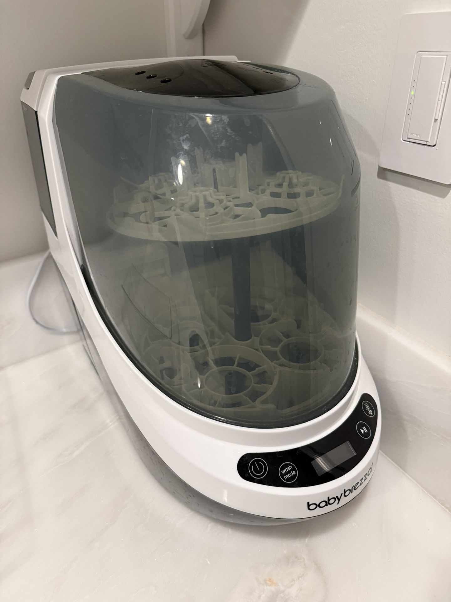 Baby Brezza Bottle Washer Pro with extra detergent tablets and descaling tablets