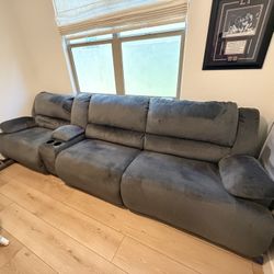 Ashley Clonmel Sofa with power recliner, two standard recliners, and one cup holder/storage unit