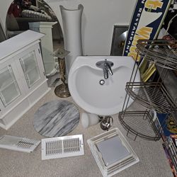 Bathroom Renovation: White Pedestal Sink, wall cabinet, oval mirror, light fixture, marble table
