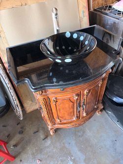 Ornate Wood Bathroom Vanity with Granite Top, Vessel Sink, and Black Toilet