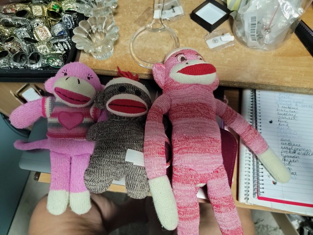 Three Sock Monkies One Red And White One Brown And One Pink And White