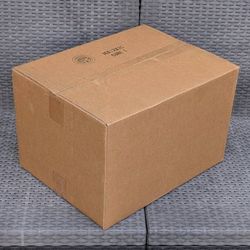Clean medium size cardboard box and long strip of thick packing paper for shipping moving or storage