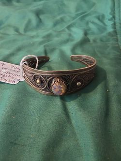 Vintage filigree cuff bracelet with an iridescent cabochon stone