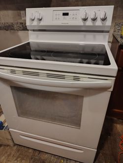 Kitchen stove and over-the-range microwave—selling together.