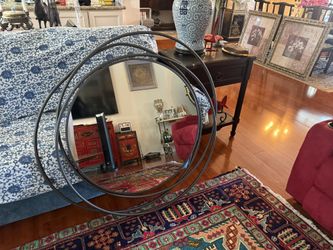 Beautiful large round wall mirror with modern black metal frame. This is a statement piece that really stands out in any room. Great for a living room
