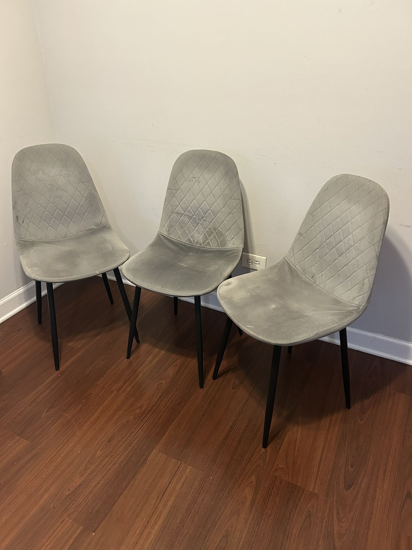 Three plush grey chairs, elegant and comfortable