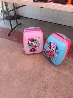2 Minnie Mouse rolling suitcases
