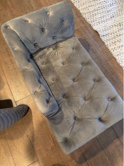 Gray tufted dog bed.