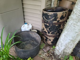 55 gallon hard plastic rain barrel and 25 gallon barrel