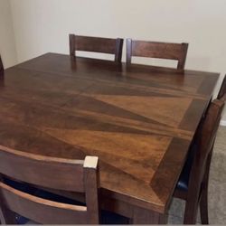 Expandable dining table complete with six chairs