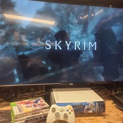 Microsoft Xbox 360 with controller and some games