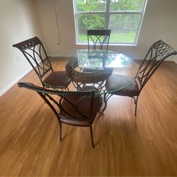 Glass top large table with 4 chairs in new like condition
